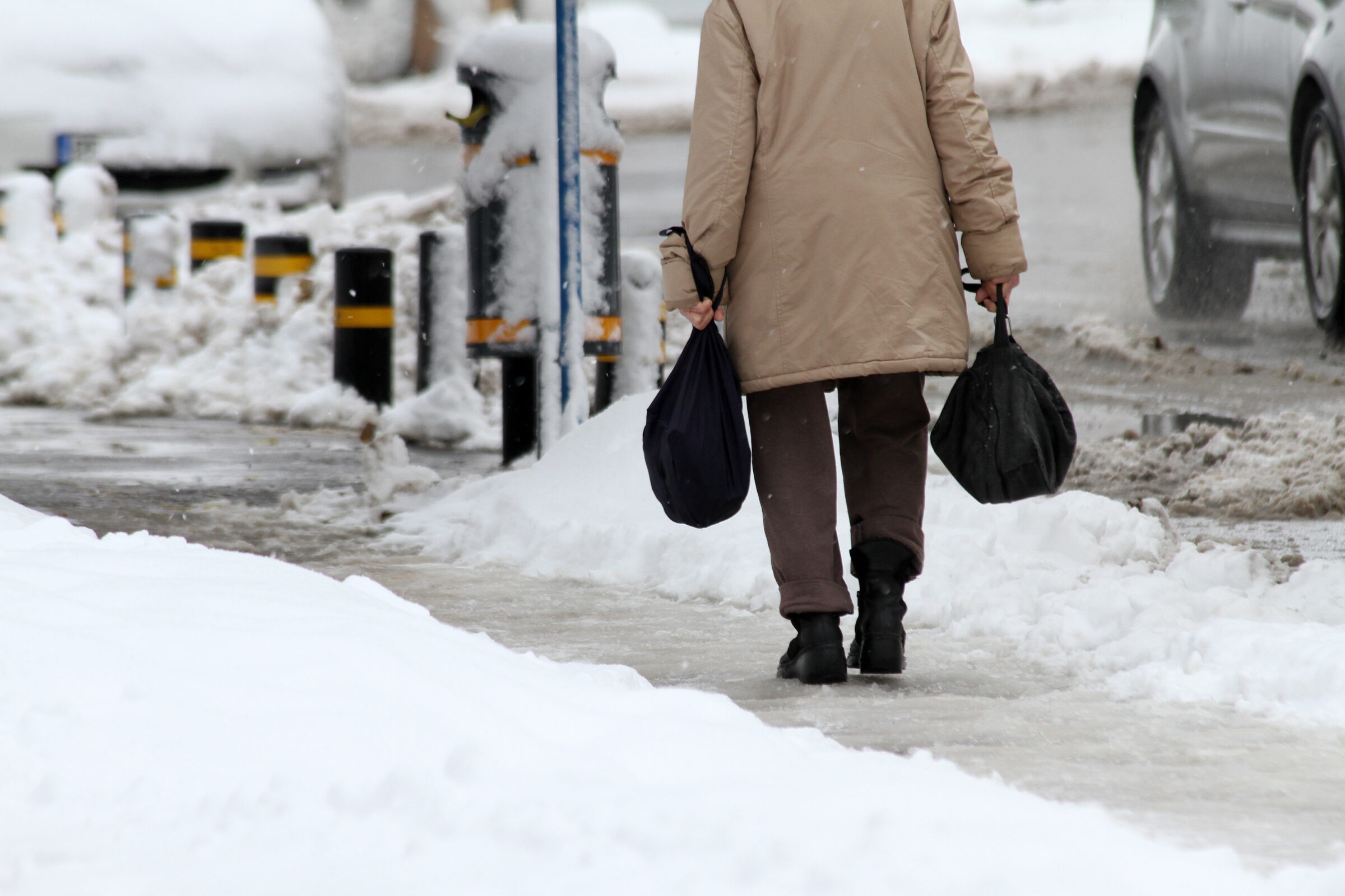 Pedestrian walking on icy sidewalk