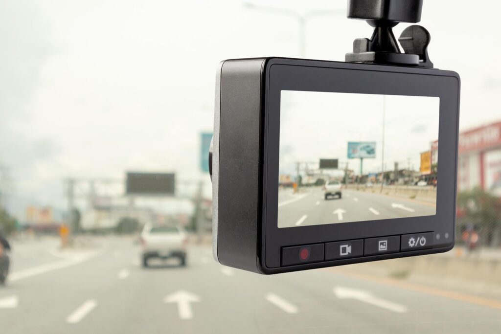 Closeup of a dash cam car camera on the highway with a pickup truck in view ahead