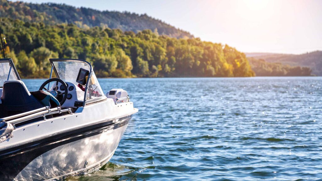 Boating, fishing on a lake at sunrise or sunset